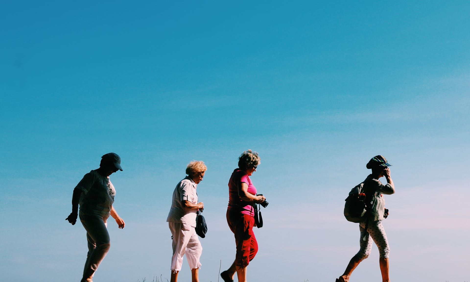 a group of people standing on top of a hill